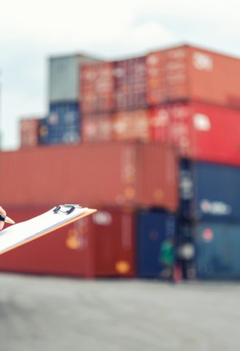 Closeup,Of,Worker,Hand,Holding,Clipboard,With,Check,Shipping,Document
