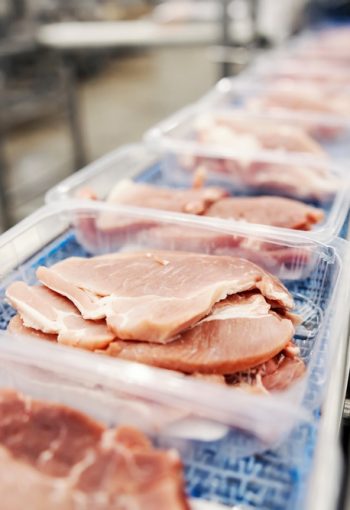 Packed,Pork,Steaks,On,Conveyor,At,Meat,Factory.